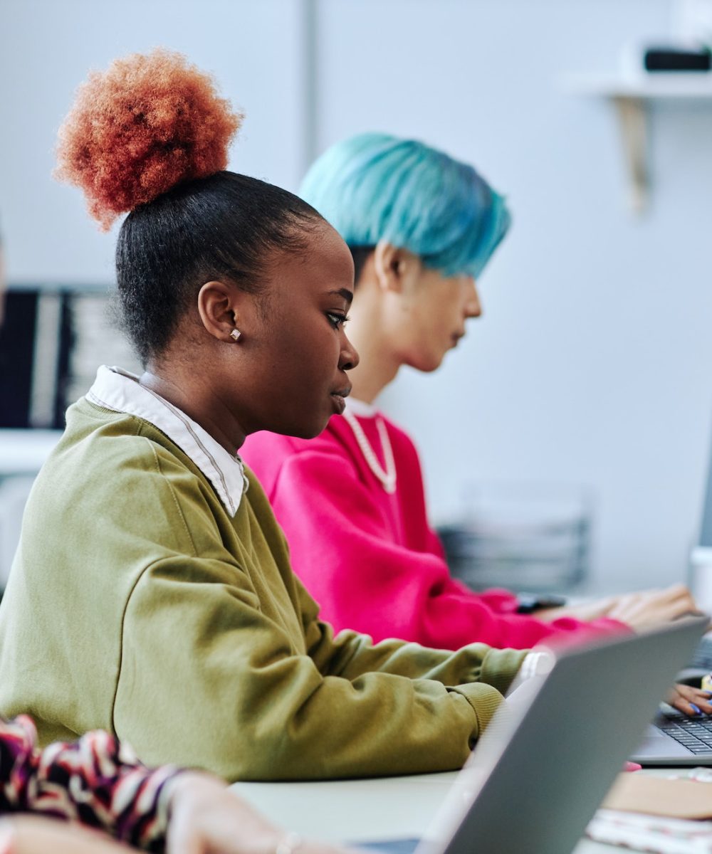 diverse-group-of-creative-young-people-sitting-in-row-working-in-office.jpg